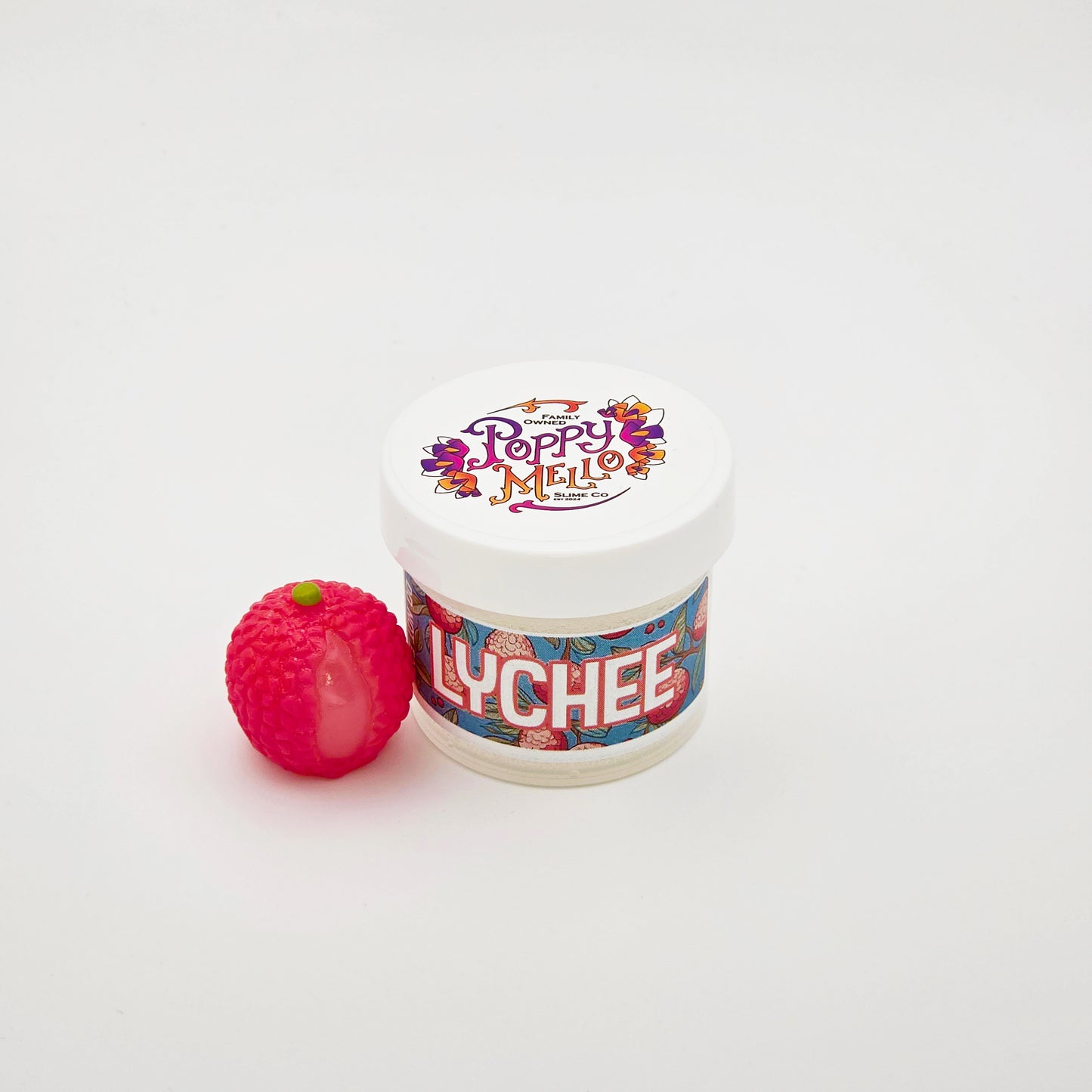 Jar of lychee-flavored slime with a small red fruit on a white background
