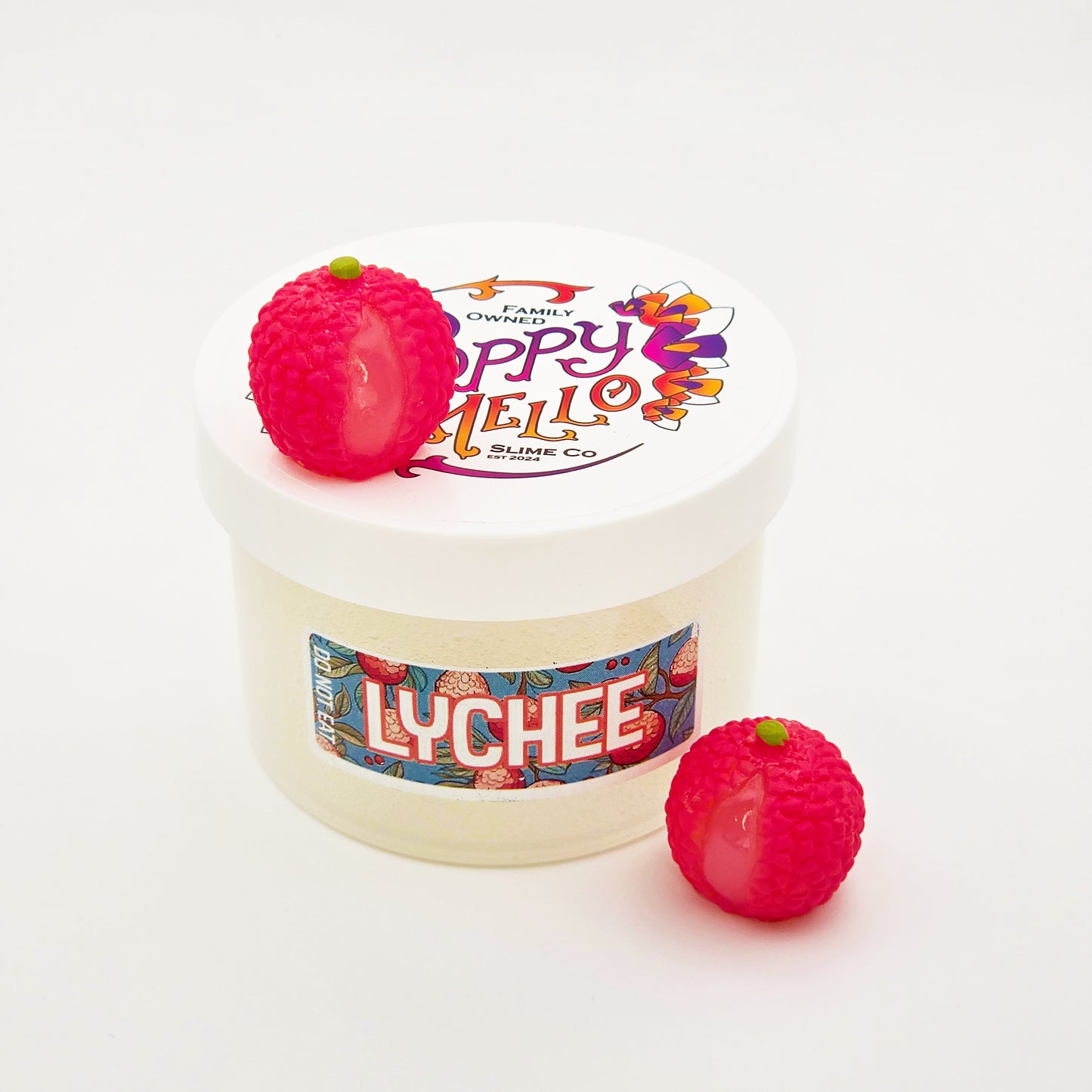 Jar of lychee-flavored slime with two lychee-shaped toys on a white background