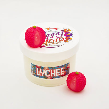 Jar of lychee-flavored slime with two lychee-shaped toys on a white background